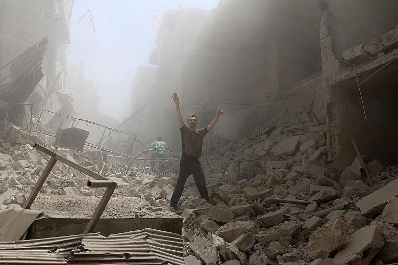 Buildings were reduced to rubble after an air strike on the rebel-held neighbourhood of al-Kalasa in the northern Syrian city of Aleppo yesterday. The Syrian army said it was preparing an offensive to retake the whole of Aleppo, as fighting killed 38