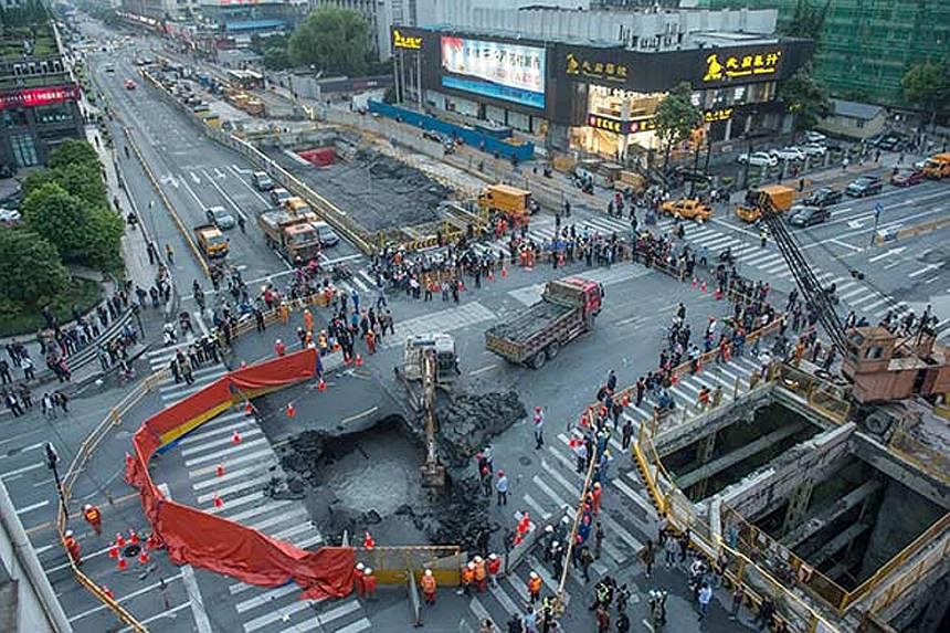 Minutes after Mr Li (below) diverted vehicles in Hangzhou last Thursday, the crack widened and became a sinkhole that could have easily swallowed three cars. Mr Li, an auxiliary traffic police officer, has been nominated for a first-class public secu