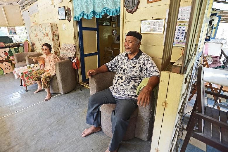 Mr Ahmad and his wife Sapiah Taib, 78, in their kampung house on Pulau Ubin. His expertise in building and repairing kampung houses and digging wells was uncovered and recorded by anthropologist Vivienne Wee and her research team as part of the first