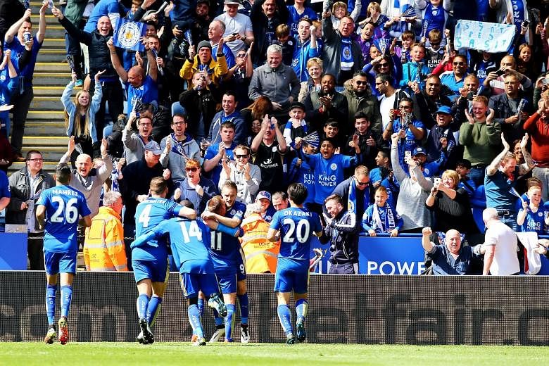 Leicester City players and fans celebrating a goal at the The King Power Stadium earlier this month. The Foxes can still win the Premier League title at their home ground against Everton next Sunday if they fail to do so against Manchester United at 