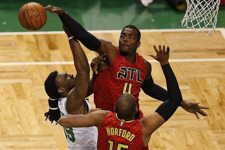 Paul Millsap (No. 4) of the Atlanta Hawks blocks a shot from Jae Crowder of the Boston Celtics during the 104-92 victory to eliminate their opponents in Game Six of the Eastern Conference quarter-finals on Thursday.