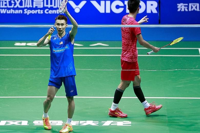 Malaysian star Lee Chong Wei (left) acknowledging the crowd in Wuhan after defeating home favourite Chen Long in the men's singles final at the Badminton Asia Championships in Wuhan yesterday. With that win, Lee has a 13-12 edge in career meetings wi