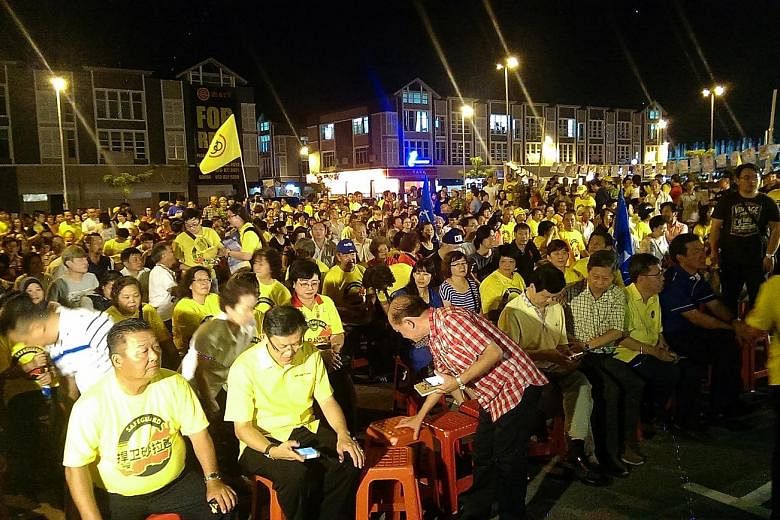 The crowd (above) at a rally featuring BN candidates in the Sarawak state elections. BN is hoping the popularity of Sarawak Chief Minister Adenan Satem will help the ruling coalition reclaim urban seats lost in the last state polls five years ago. Ma