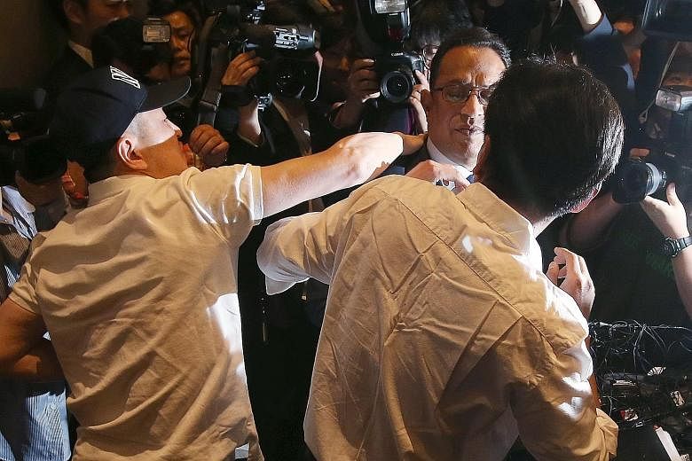 It was chaos at one point as some victims' relatives surrounded Mr Safdar during a press conference in Seoul yesterday at which he apologised for his firm's role in selling a humidifier disinfectant blamed for more than 100 deaths in South Korea.