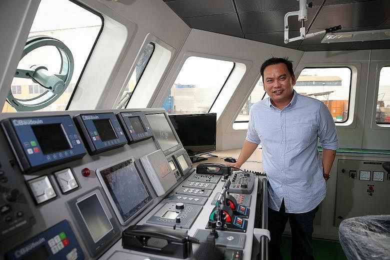 Mr Tan in the wheelhouse of the DM Ascentia, an aluminium crew boat built by Dundee Marine and Industrial Services. The firm used to focus mostly on ship repairs but has since diversified into aluminium boat building.