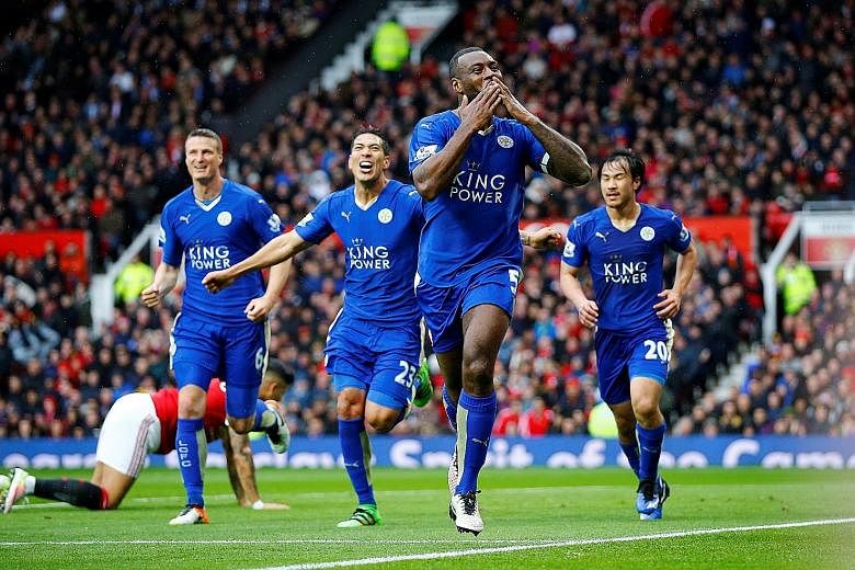Leicester City's Wes Morgan (foreground) blows kisses to the fans after scoring the equaliser in the Premier League match against Manchester United at Old Trafford on Sunday.