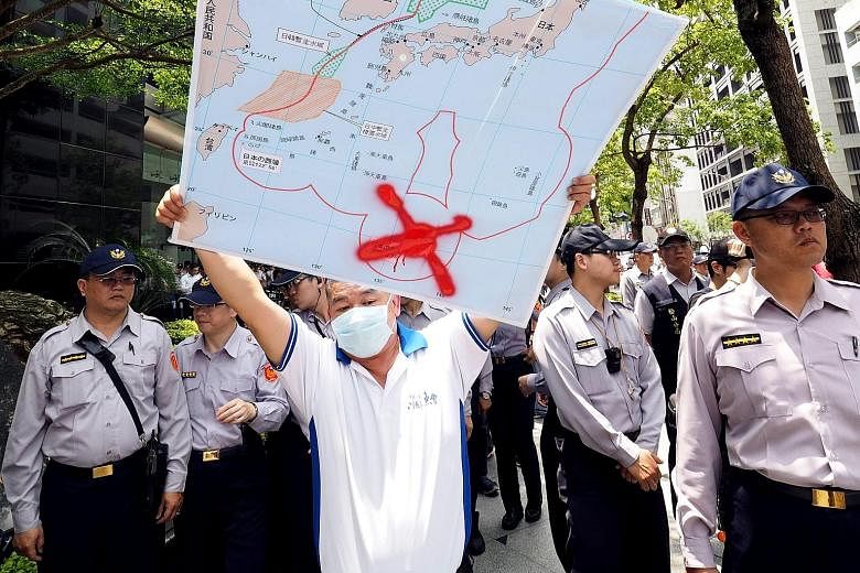 A Taiwanese fisherman with a map showing the location of Okinotorishima Island crossed out, during a protest last month over Japan's seizure of a Taiwanese trawler there.