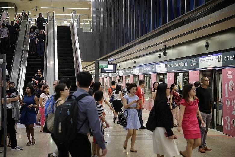 Commuters at Downtown Line 2's Bukit Panjang station a day after its opening on Dec 27 last year. The new line had its first major breakdown yesterday when a train inexplicably applied its emergency brakes. The fault took around half an hour to resol