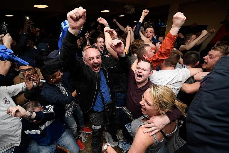 Leicester City fans celebrating their team becoming the English Premier League champions in central Leicester on Monday after Chelsea held Tottenham Hotspur to a 2-2 draw.