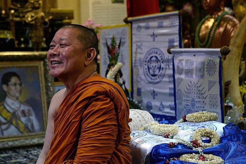 The Leicester-supporting Thai monk Phra Prommangkalachan with the Foxes' banners. He believes the team will do well in next season's Champions League.