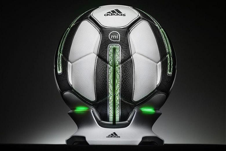 The adidas miCoach Smart Ball comes with a futuristic wireless charging dock.