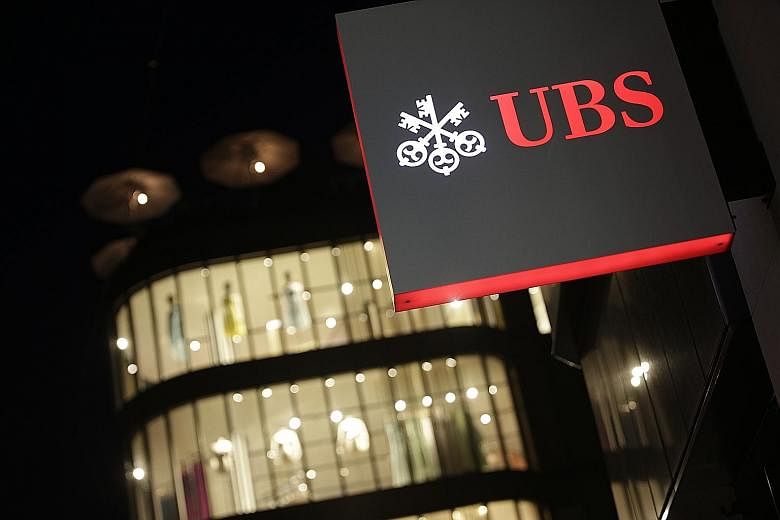 A branch of the UBS Group in Zurich. Switzerland's biggest bank yesterday reported net profit for the first three months fell by 64 per cent to 707 million Swiss francs (S$999 million).