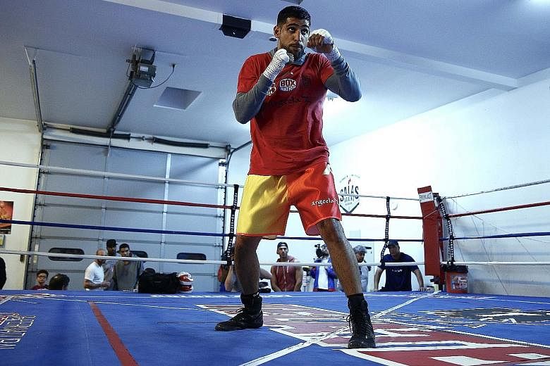 Amir Khan training ahead of his middleweight title fight with Saul "Canelo" Alvarez. The British boxer has relished stepping into the limelight that was reserved for Floyd Mayweather before the American hung up his gloves.