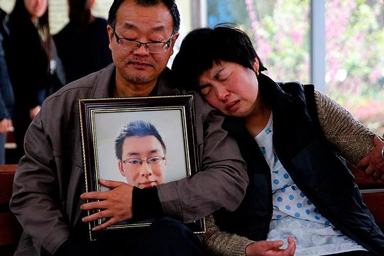 The parents of Mr Wei Zexi, a computer science major at Xidian University in Shaanxi province who died of a rare form of cancer, outside a funeral home last month.
