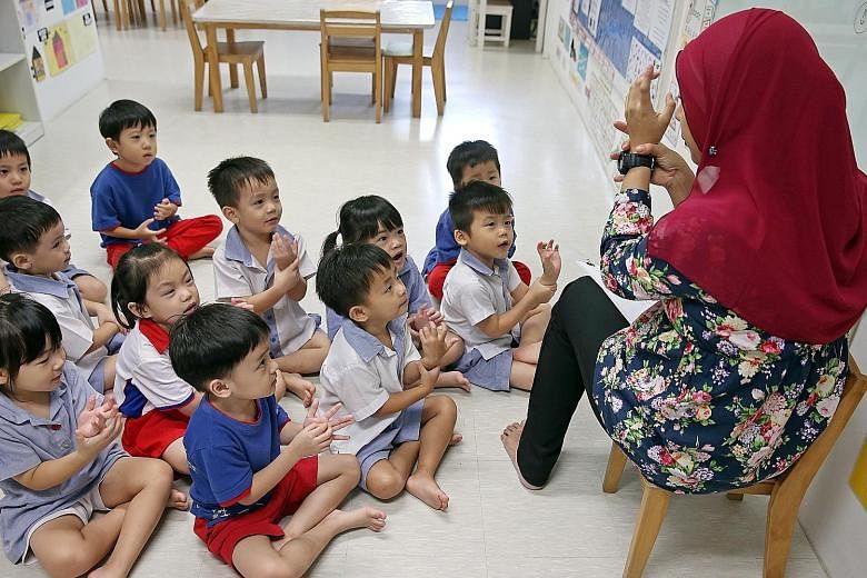 A pre-school teacher with her Nursery 2 class at PCF Sparkletots Preschool@ Fengshan. The Early Childhood Development Agency has launched a programme to help pre-school teachers progress in their careers and take on larger roles. The scheme will put 