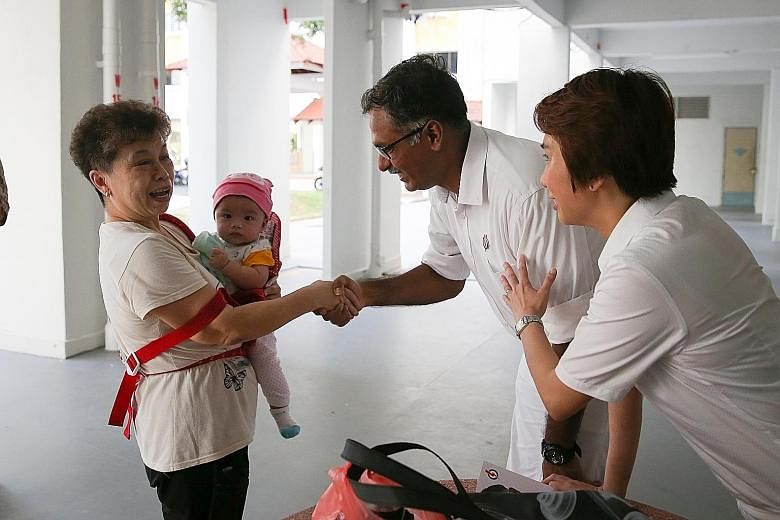 Mr Murali, accompanied by South West District Mayor Low Yen Ling, meeting a resident on the campaign trail yesterday. He says his discussions with residents has helped him to refine details of his plans for the area.