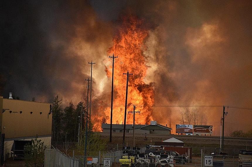 Flames rising in the industrial area of Fort McMurray in Alberta, Canada, on Tuesday. Hot and dry weather has made it hard for firefighters to bring the fire under control. No casualties have been reported but much of one neighbourhood in the city ha