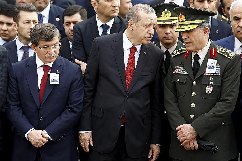 It was thought that Mr Davutoglu (at far left) would be a puppet premier when he became PM in 2014, but instead, he has made efforts to carve out his own profile, to the possible irritation of Mr Erdogan (centre), seen here talking with Chief of Staf