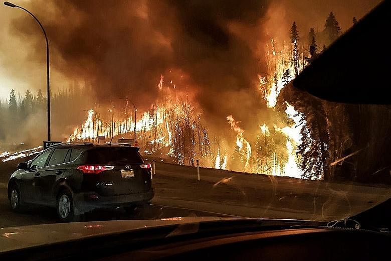 A picture provided by Twitter user @jeromegarot yesterday shows a wildfire raging through Fort McMurray on Tuesday.