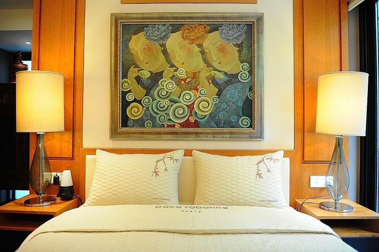 Another painting by artist Liu Jianhua (above) takes pride of place above the bed. The bedroom is modelled on the rooms at Four Seasons Hotel in Guangzhou.