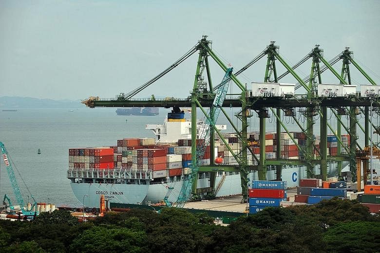 A Cosco container vessel being unloaded at the Singapore Port. The company's revenue in the three months ended March 31 fell 27 per cent from a year earlier to $722.3 million as both shipyard and dry bulk shipping revenues fell.
