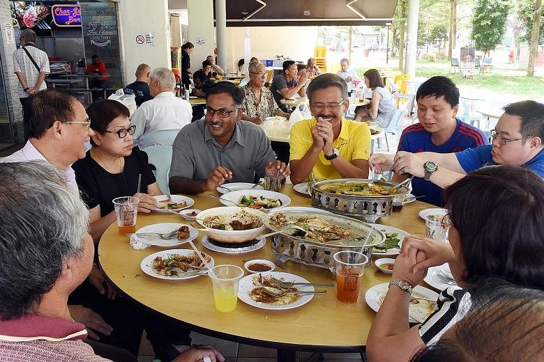 Dr Chee (second from left), having a picnic with Singapore Democratic Party members and volunteers at the Botanic Gardens yesterday afternoon. He spent the rest of the day with his family, said a party spokesman. Mr Murali (third from left) having lu
