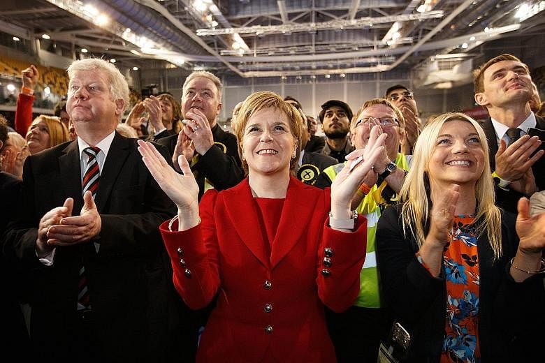 Ms Sturgeon (centre) is all smiles after her Scottish National Party won a "historic" victory in regional polls. However, having lost its outright majority, SNP must get the support of a smaller party to govern.