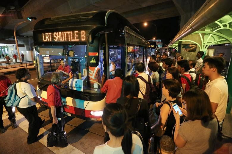 Commuters taking a free shuttle service at Choa Chu Kang LRT station in March last year when the Bukit Panjang LRT was shut down after a fire. 