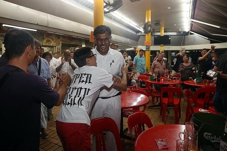 Mr Murali being congratulated at a coffee shop in Bukit Batok after his by-election win yesterday.