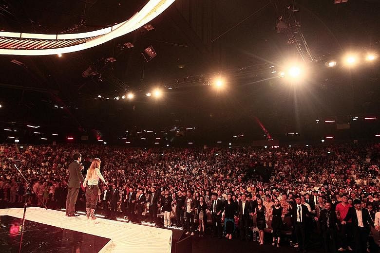 Kong and his wife, Ms Ho, leading worshippers during a service in 2013 at its auditorium in the Suntec Convention Centre. Kong and five other City Harvest Church leaders were found guilty of fraud and sentenced to between 21 months and eight years in