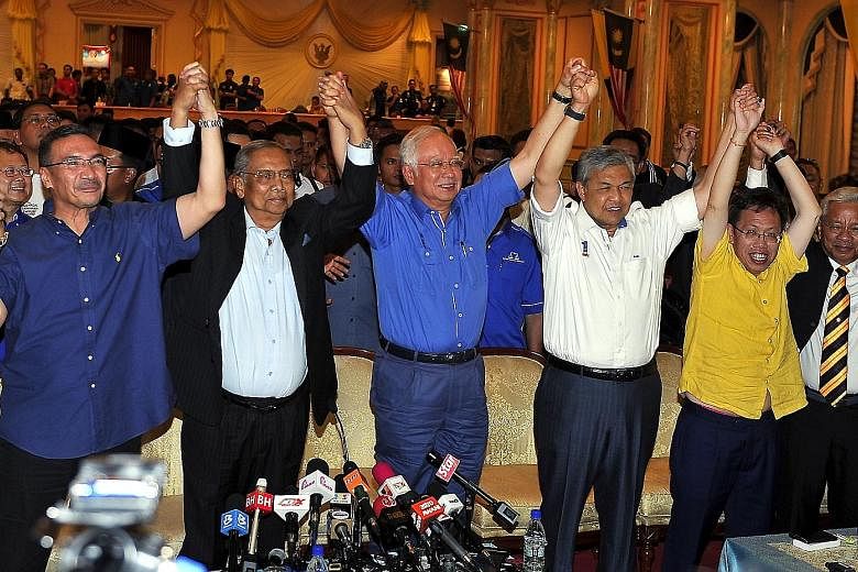 Malaysian Prime Minister Najib Razak (centre) celebrating with Chief Minister Adenan Satem (in black jacket) after Barisan Nasional's success in the Sarawak state election yesterday.
