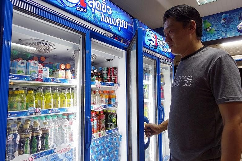 Bangkok shopkeeper Chaiwat Pawanthapong disagrees with the proposal to impose a tax on sugary drinks. He says it would be a burden on people already grappling with gloomy economic conditions.