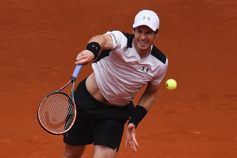 World No. 2 Andy Murray serving to rival Rafael Nadal in their Madrid Open semi-final yesterday. The defending champion recorded eight aces and saved 11 break points to hand Nadal his first loss in 14 matches.