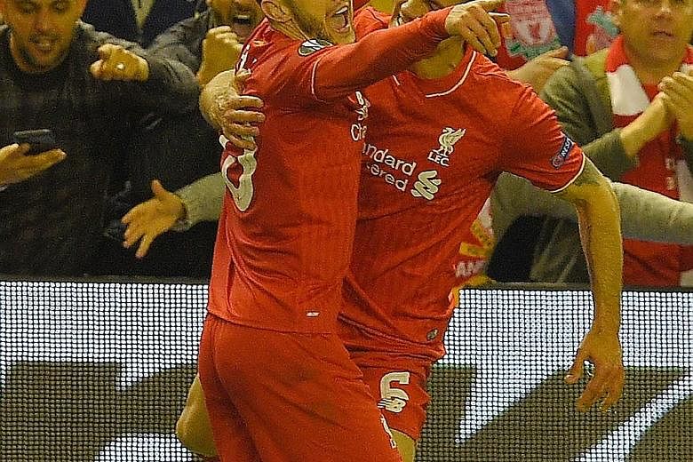 Liverpool midfielder Adam Lallana (left) celebrates with Dejan Lovren after scoring against Villarreal on Thursday. It was his fifth goal in 14 European matches this season. In 22 league games, he has four goals.