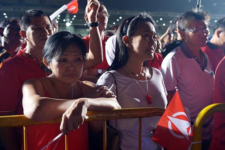 SDP supporters listening to Dr Chee's speech at Bukit Gombak Stadium after his loss yesterday.
