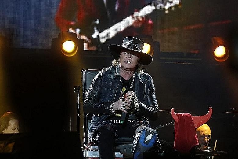 Singer Axl Rose (foreground) performing at the Lisbon gig of Australian rock band AC/DC. 