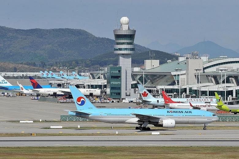 Flight SQ16, carrying 186 passengers and 18 crew, was departing from South Korea's Incheon airport (left) last Thursday when a Korean Air jet taxied near an intersection on the runway without permission. SIA pilots aborted the take-off in time to avo