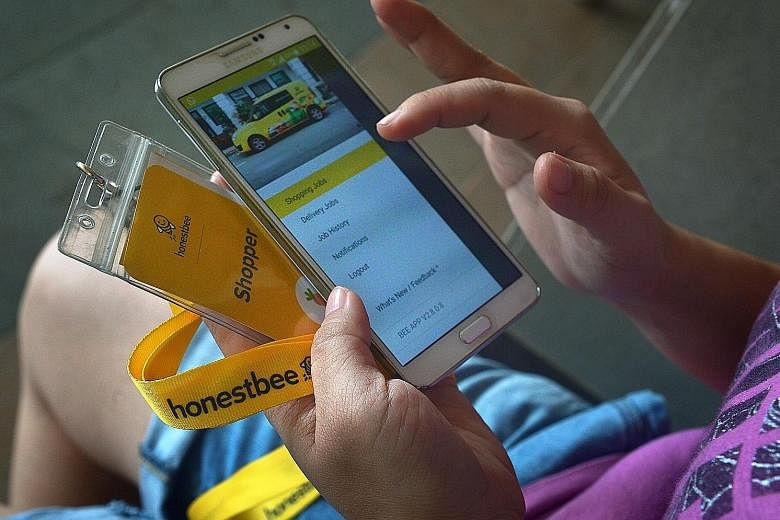 An honestbee shopper checking an app through which shoppers receive orders they have to fill at supermarkets. The firm's CEO and co-founder Joel Sng said shoppers' pay fluctuates based on customer demand.
