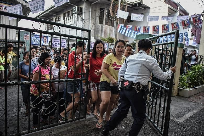 Voters entering a polling centre in Manila yesterday. Analysts said that with Mr Duterte poised to become the next president of the Philippines, it may be time for the nation to move beyond the elections.