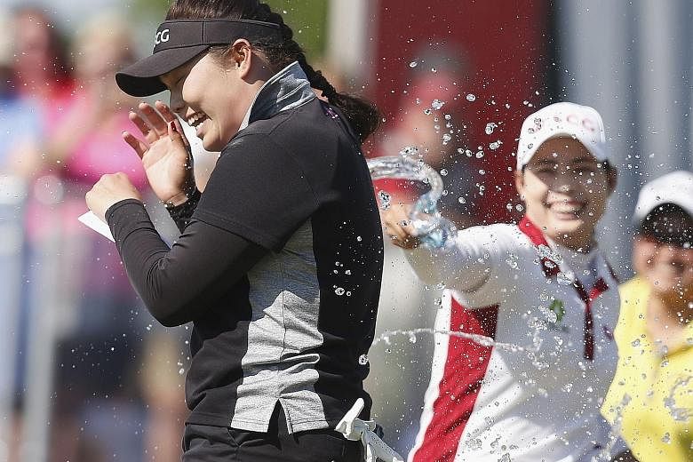 Ariya Jutanugarn being sprayed with champagne as she celebrates winning the Yokohama Tire Classic with her sister, Moriya. The Thai golfer had needed a par putt in her final hole to confirm her victory.