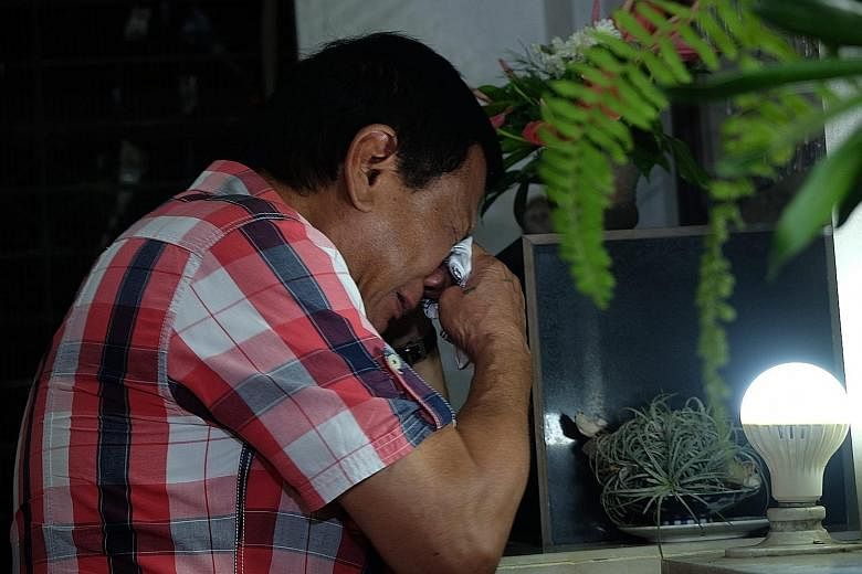 An emotional Mr Duterte visiting his parents' tomb at San Pedro Memorial Park in the Philippine city of Davao yesterday morning, after he secured the presidency. It is not clear when his victory will be officially declared, but the former Davao mayor
