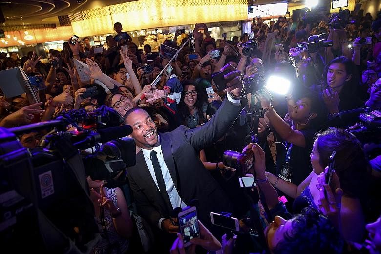Anthony Mackie, one of the stars of the blockbuster film Captain America: Civil War, surrounded by fans at the blue carpet event at Marina Bay Sands last month.