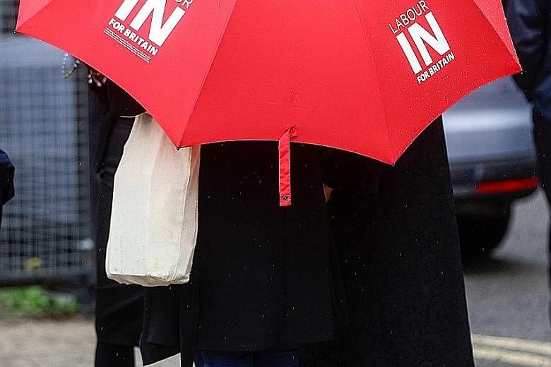 An umbrella with the slogan "Labour In For Britain". Mr Jeremy Corbyn, leader of the opposition Labour Party, has said that his party is in favour of staying in the EU.
