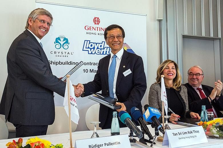 Mr Lim, Genting Hong Kong chairman, with Lloyd Werft Group CEO Ruediger Pallentin (left) in Germany on Tuesday. Deals were signed for the construction of several cruise vessels, including two "global class" ships (such as the one in the photo).