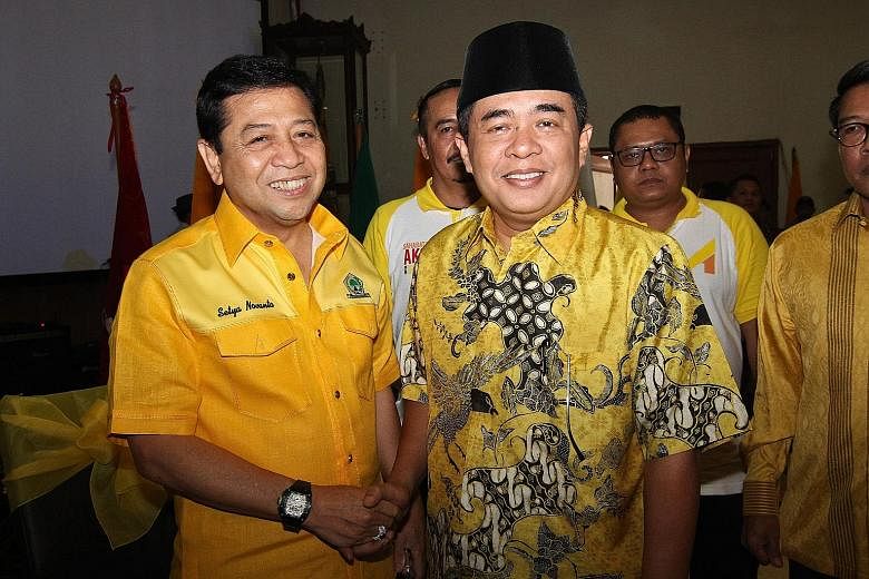 Mr Setya Novanto (at left) and House Speaker Ade Komarudin at the Golkar party headquarters in Jakarta last Saturday. Both men are among eight members campaigning for the post of Golkar chief, and experts see the contest as a straight fight between t