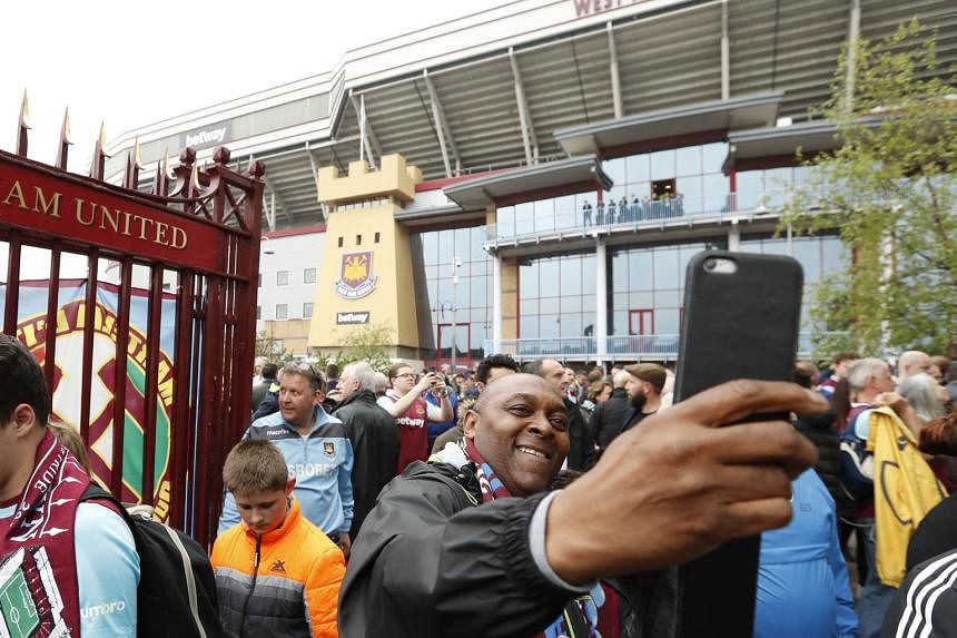 A West Ham fan takes a selfie outside Upton Park, before the elaborate commemorative celebrations drew down the final curtain on 112 years of football at the historic venue.