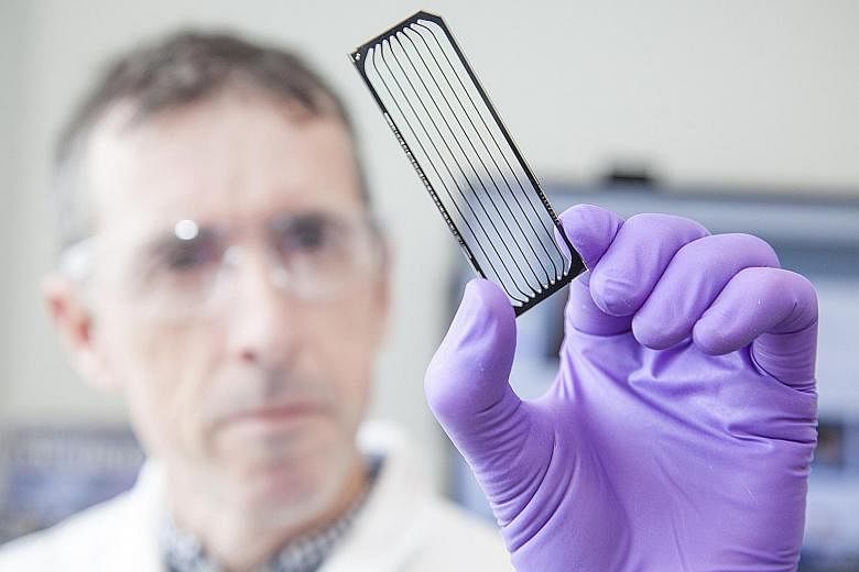 A scientist looking at a flow cell as part of cancer research. Among the game changers identified by cancer experts are cellular immunotherapy and nanotechnology.