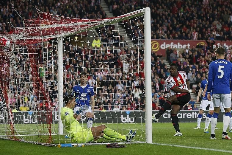 Lamine Kone (left) scores the third goal for Sunderland in their 3-0 win, which secured their escape from relegation. 