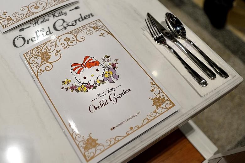 Many people queued for hours at Terminal 3 yesterday to be among the first to dine in the Hello Kitty-themed cafe (above), which is the world's first to be open round the clock. The cafe's menu (left) is Singapore-inspired, with dishes such as wagyu 