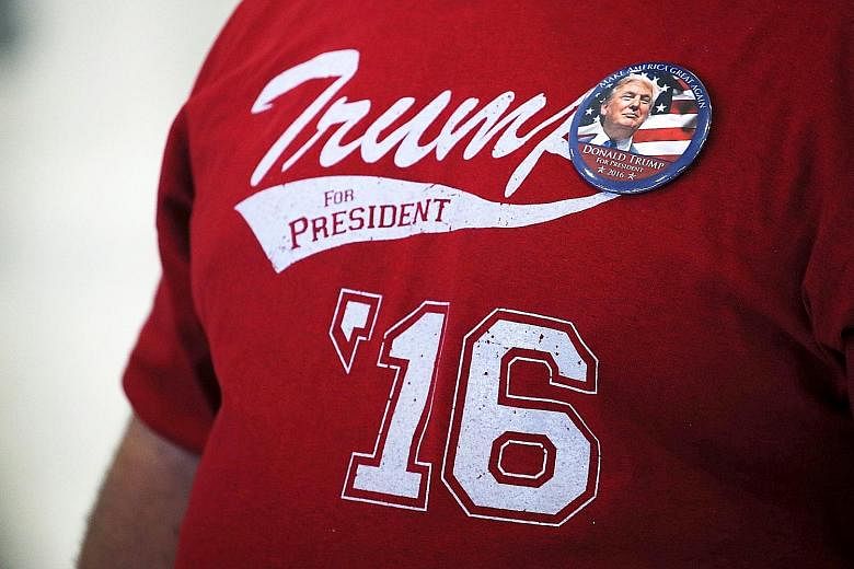 A Donald Trump supporter at a campaign rally. Analysts say the presumptive Republican presidential nominee must change his campaign tone and find ways of reaching out to female voters and racial minorities - as well as those who have lost their jobs 